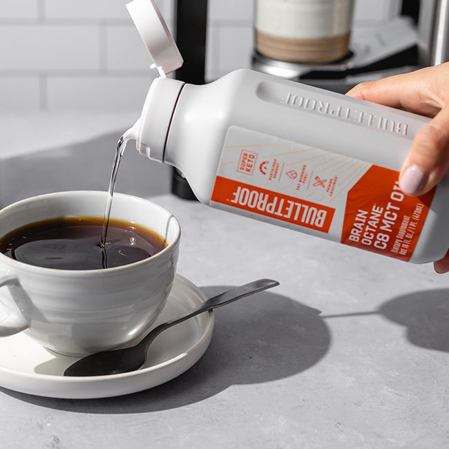 Bulletproof Brain Octane C8 MCT Oil pouring into coffee mug
