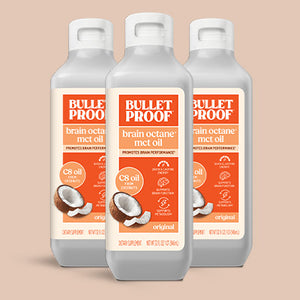 Three bottles of Bulletproof brain octane mct oil on a beige background