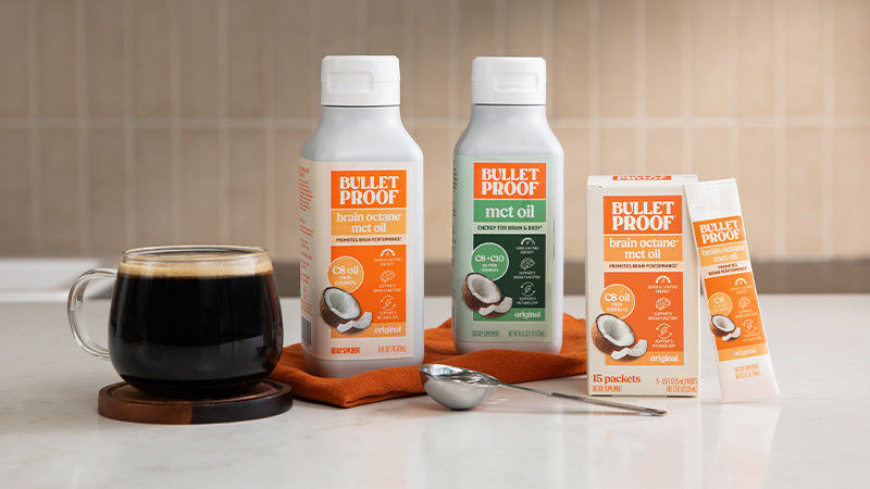 Bulletproof products including coffee, oil, and coconut oil packaging on a kitchen counter.