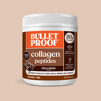 Container of Bulletproof chocolate collagen peptides on a beige background