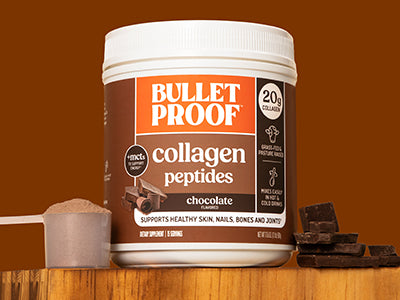 Bulletproof Chocolate Collagen Peptides container next to scoop of collagen