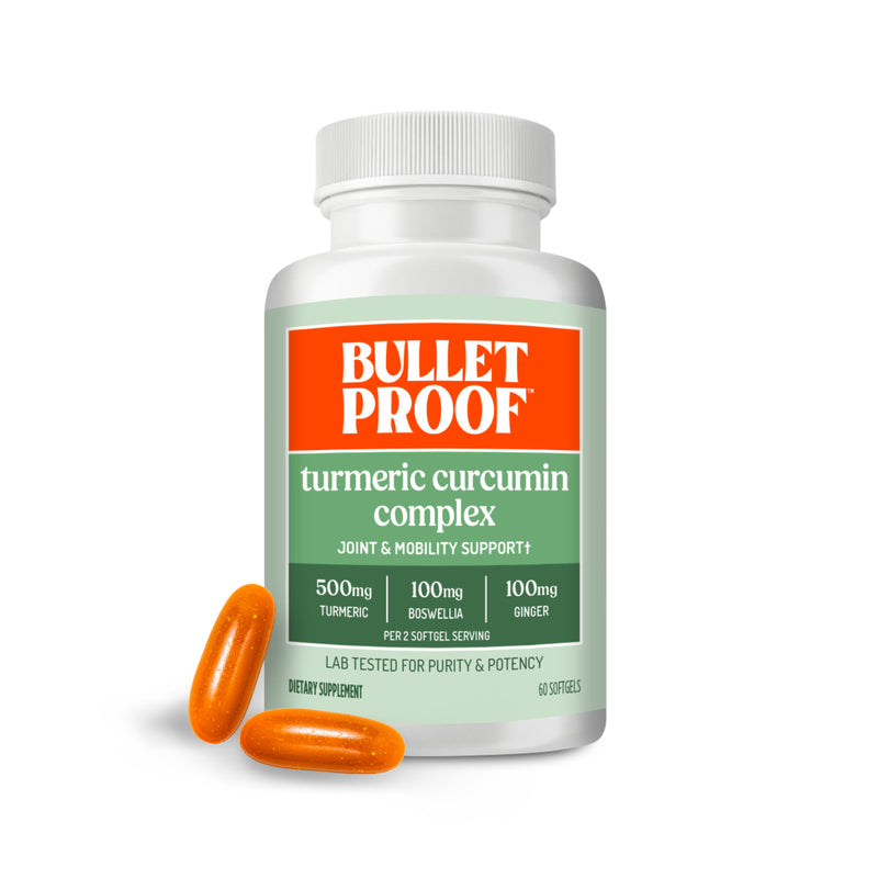 Bulletproof Turmeric curcumin complex supplement bottle next to two softgels