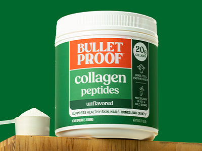 Bulletproof Unflavored Collagen Peptides container next to scoop of collagen