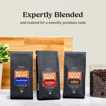 Image of bulletproof coffee packages, French Kick, The Mentalist, and Original. Expertly Blended and roasted for a smooth, premium taste. Bulletproof French Kick whole bean 12 oz, the Original Bulletproof whole bean 12 oz, and the Bulletproof mentalist whole bean 12 oz. on a kitchen counter