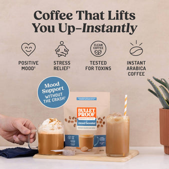 Bulletpoof Coffee mood booster latte package displayed on a tabletop with iced coffee drinks, a hand holding a coffee mug, and marketing text above reading 'Coffee That Lifts You Up-Instantly' with feature icons.