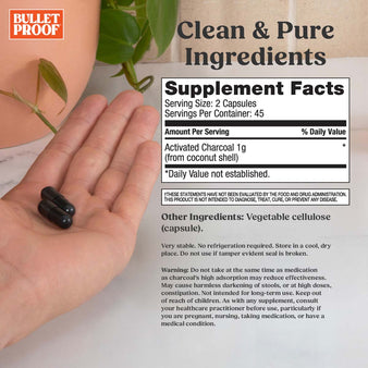 clean & pure ingredients. Supplement facts for the Bulletproof coconut charcoal. A hand holding two capsules of coconut charcoal.