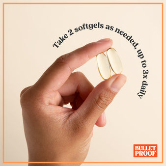 Hand holding two Bulletproof supplements