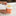 Person scooping Bulletproof enhanced creamer from a jar on a kitchen counter.