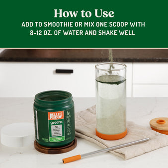 Bulletproof Greens on kitchen counter with powder being poured into glass of water. Add to smoothie or mix one scoop with water and shake well.