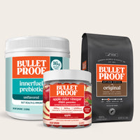 Bulletproof products including a container, gummies, and coffee bag on a beige background