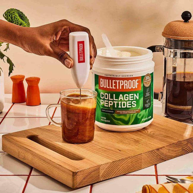 Bulletproof Unflavored Collagen Peptides scoop blended in coffee mug with frother