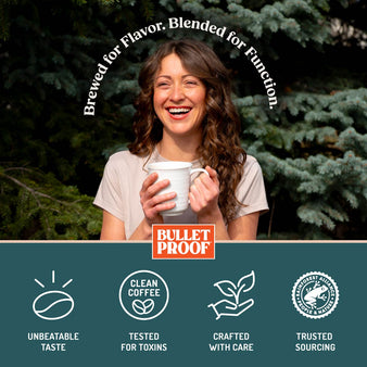 Woman holding a mug with Bulletproof logo and text about coffee quality, outdoors.