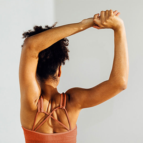 Woman holding hands over head and stretching